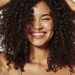 happy-woman-with-curly-hair-smiling